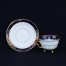 Komplet do mokki wykonany z białej porcelany zdobionej kobaltowym pasem ze złotym ornamentem