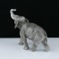 Porcelanowa figurka kroczącego słonia z uniesioną trąbą