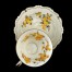 Żółta mimoza zdobi kremowa porcelanę ze złoceniami