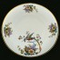 Rajski ptak i kwiaty o ciekawych kolorach na kremowej porcelanie