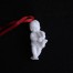 Biała porcelana biskwitowa- figuralna bombka - zawieszka putti